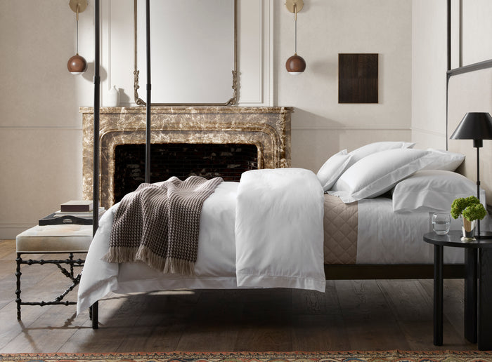 Matouk Bergamo Giza percale hemstitch sheets on a sunlit bed.